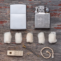 Windproof Lighter components layed out, including lighter insert and wick