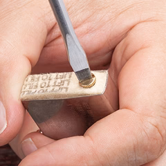 Bottom felt pad being placed over the flint tube and screw reinstalled